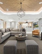 a large living room with a chandelier and a large couch